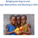 Three smiling children holding oranges against a gray backdrop